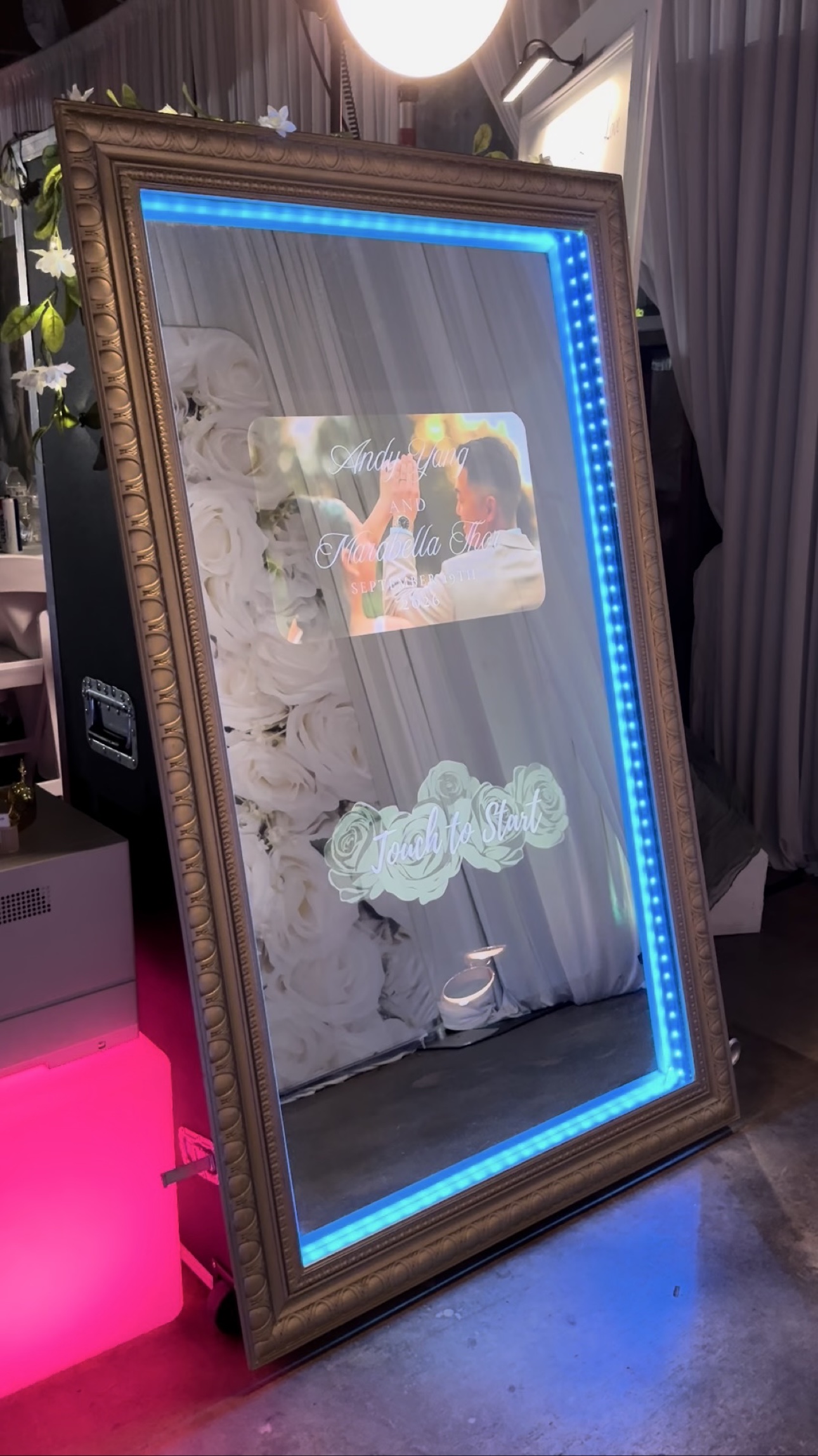 Golden-framed interactive mirror photo booth set up at an event